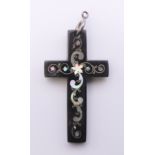 A mother-of-pearl inlaid tortoiseshell cross. 6.25 cm high.