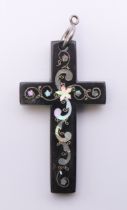 A mother-of-pearl inlaid tortoiseshell cross. 6.25 cm high.