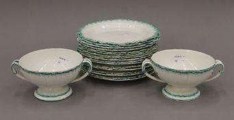 A quantity of Wedgwood Cream Ware plates and two matching twin handled bowls.