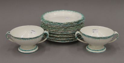 A quantity of Wedgwood Cream Ware plates and two matching twin handled bowls.
