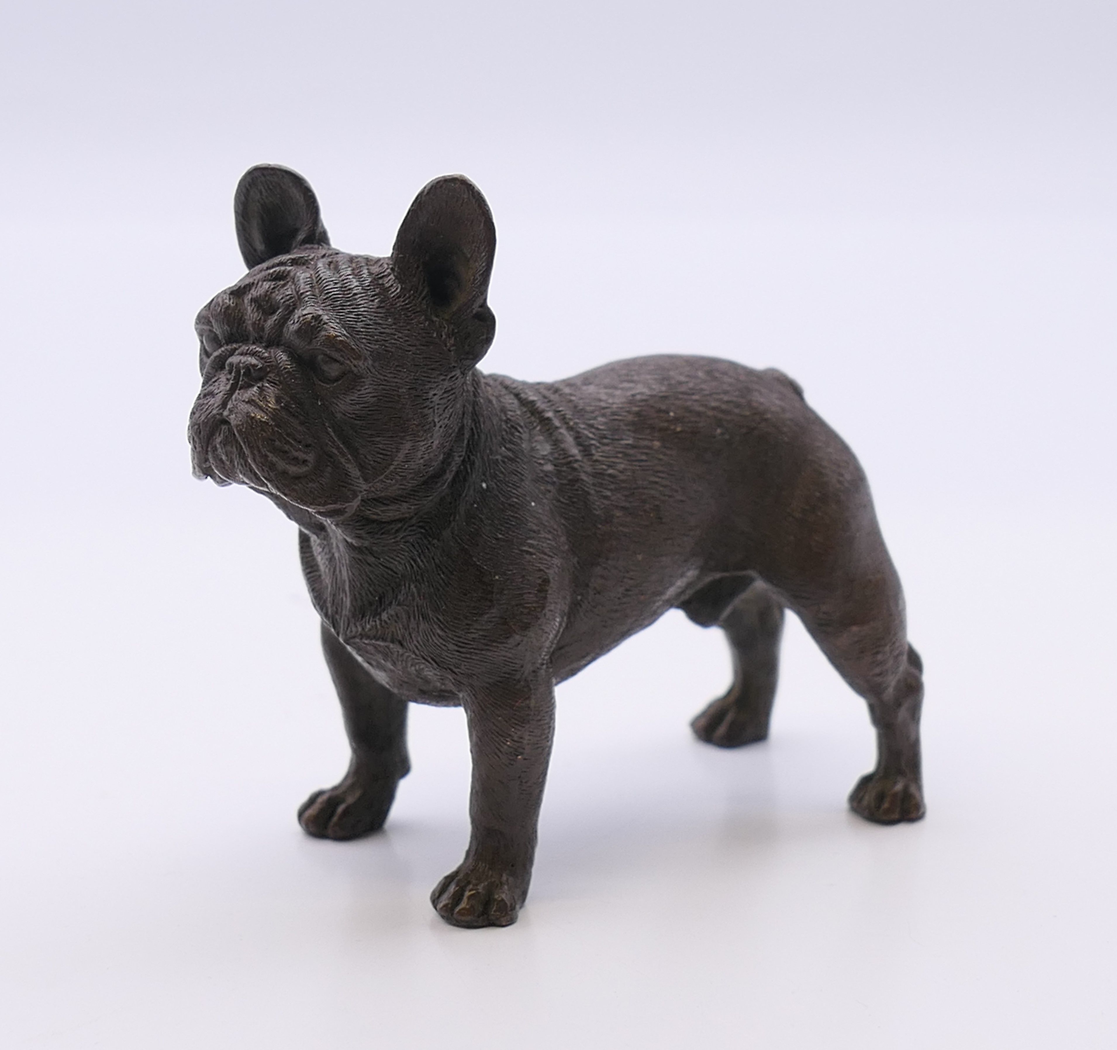 A bronze model of a French bulldog. 6.5 cm high.