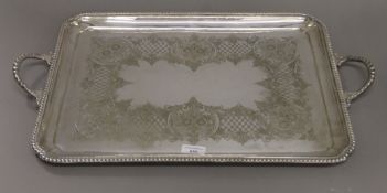 An engraved silver plated tray. 63 cm wide.