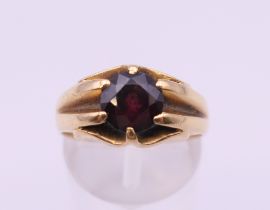 An 18 ct gold garnet ring. Ring size N/O. 7.4 grammes total weight.