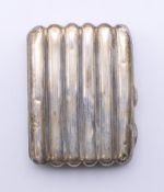 A silver section cigarette case. 8.5 cm wide.