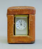 A miniature carriage clock in box. 8.5 cm high overall.