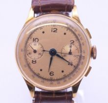 An 18 ct gold gentleman's chronograph wristwatch. 3.5 cm wide. 41.2 grammes total weight.