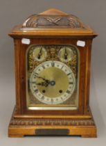 A Victorian walnut mantle clock with presentation plaque. 41 cm high.