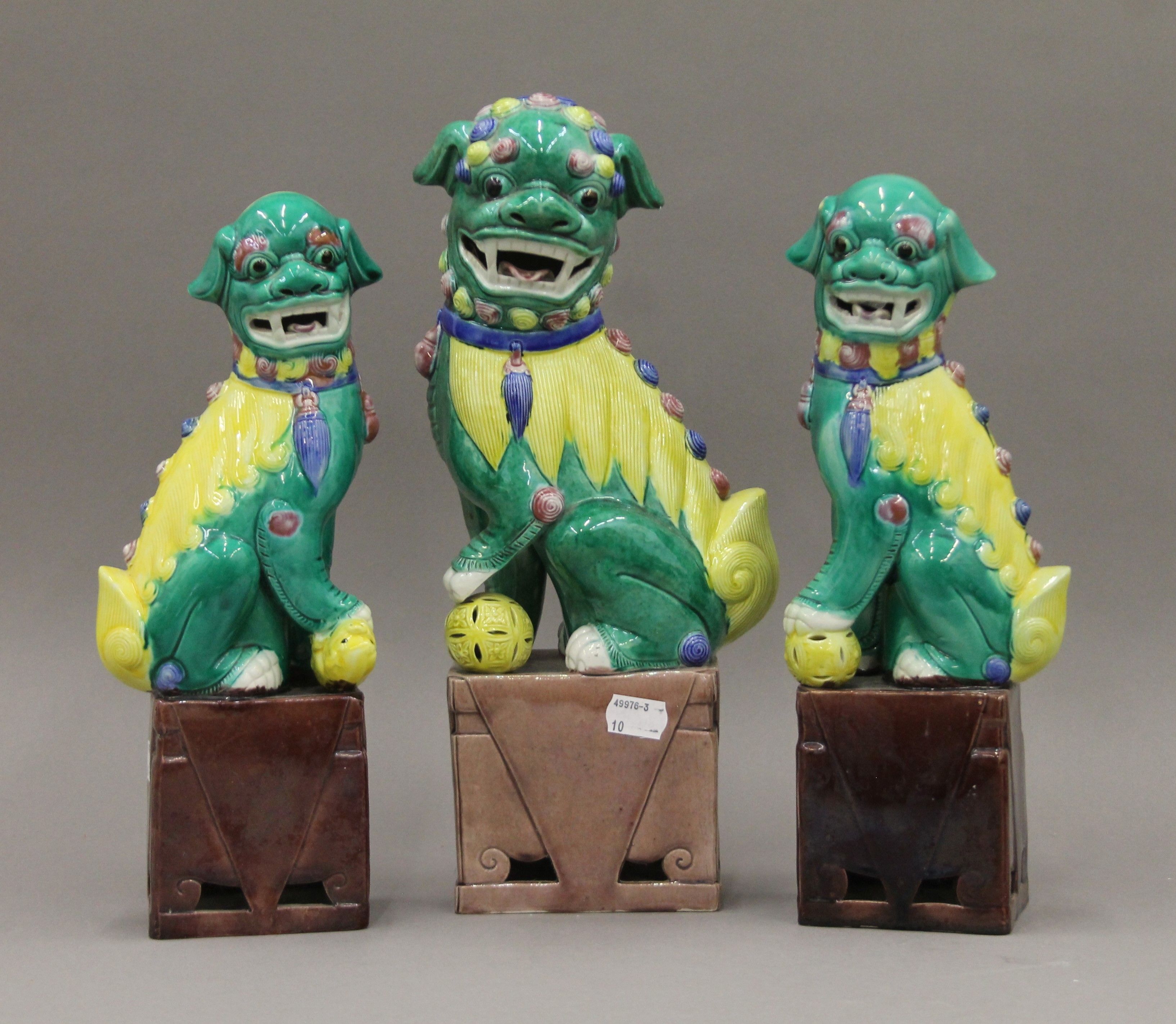Three Chinese porcelain models of dogs-of-fo. The largest 35.5 cm high.