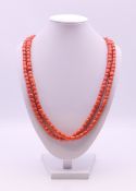 A string of coral beads set with an 18 ct gold clasp. 118 cm long.