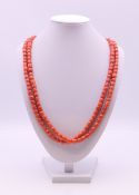 A string of coral beads set with an 18 ct gold clasp. 118 cm long.
