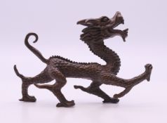 A bronze model of a dragon. 10.5 cm long.