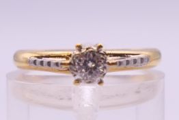 An 18 ct gold diamond solitaire ring. Ring size K. 2.5 grammes total weight.