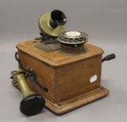 An antique wall telephone. 25 cm high.