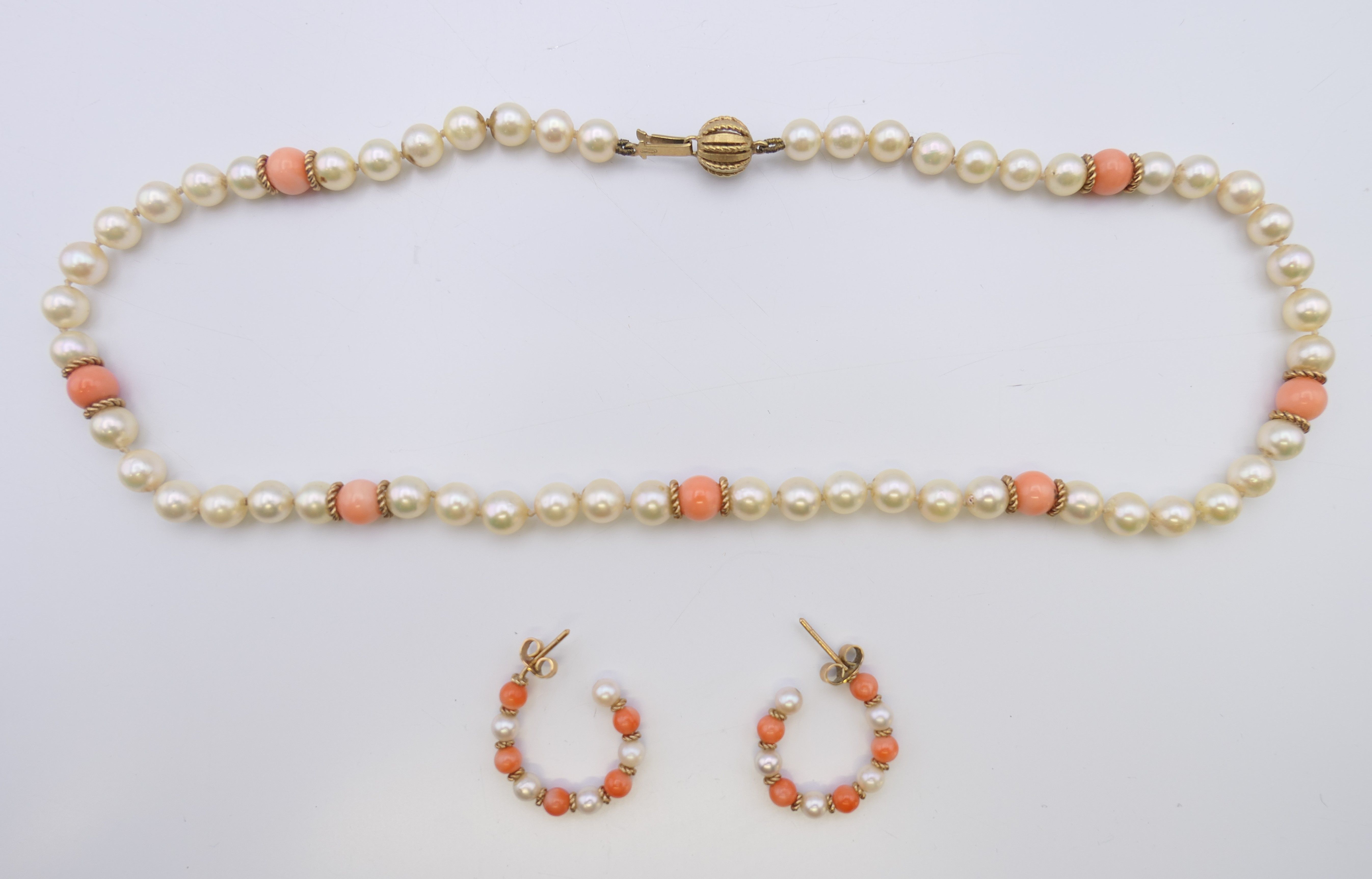 A coral and seed pearl necklace with a 15 ct gold clasp, with matching earrings.