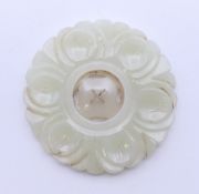 A moving section jade roundel. 5 cm diameter.