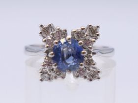A platinum sapphire and diamond cluster ring. Ring size N.