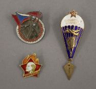 Three Soviet enamel badges, including a 1960 Student Games and the Parachute Regiment.