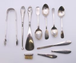 A quantity of various silver and silver handled items, including a pair of sugar tongs,