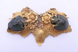 A Victorian gilt brooch set with two scarab beetles. 5 cm wide.