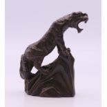 A bronze model of a tiger. 5 cm high.