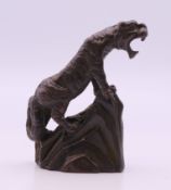 A bronze model of a tiger. 5 cm high.
