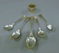 Five silver plated spoons and a silver napkin ring. The latter 45.3 grammes.