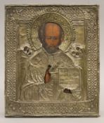 A 19th century Russian icon painted on wood depicting St Nicholas holding an open book,