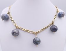 A 9 ct gold and lapis necklace. 39 cm long. 54.9 grammes total weight.