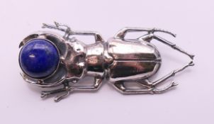 A silver lapis beetle brooch. 5.5 cm long.