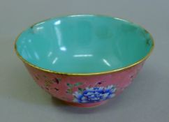 A Chinese pink ground porcelain bowl. 16 cm diameter.