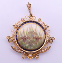 A gold and seed pearl pendant centred with a Satsuma porcelain plaque. 4 cm wide.