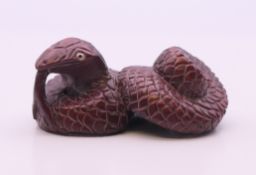 A netsuke formed as a snake. 5 cm long.