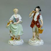 A pair of Continental porcelain figures. The largest 25 cm high.