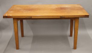 A teak drawer leaf dining table. 252 cm long extended x 79.5 cm wide.