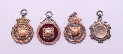 Four silver gold and enamel Albert chain fobs. 38.5 grammes total weight.