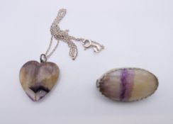 A blue john brooch and a blue john heart form pendant. The former 3 cm wide.