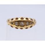An 18 ct gold three stone diamond ring. Ring size G.