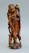 A Chinese carved wooden figure. 28 cm high.