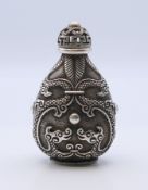 A Chinese white metal snuff bottle. 9 cm high.