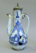 An 18th century Chinese silver mounted blue and white porcelain wine ewer. 25 cm high.