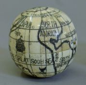 A bone globe compass. 7 cm high.