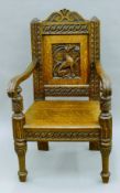 A Victorian carved oak open armchair. 58 cm wide.