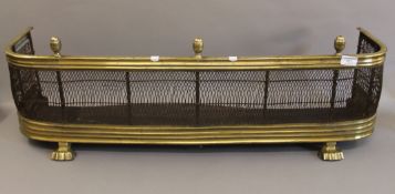 An early 19th century brass and iron fireside fender. 91 cm long.