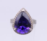 An 18 ct white gold diamond and purple stone set ring (small diamond chip missing). Ring size H/I.