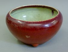 An 18th century Chinese sang de boeuf pottery bowl. 21 cm diameter.