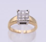 An 18 ct gold nine stone diamond ring. Ring size K/L. 4.4 grammes total weight.