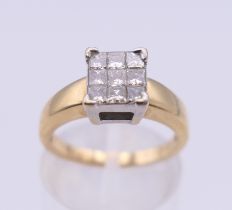 An 18 ct gold nine stone diamond ring. Ring size K/L. 4.4 grammes total weight.