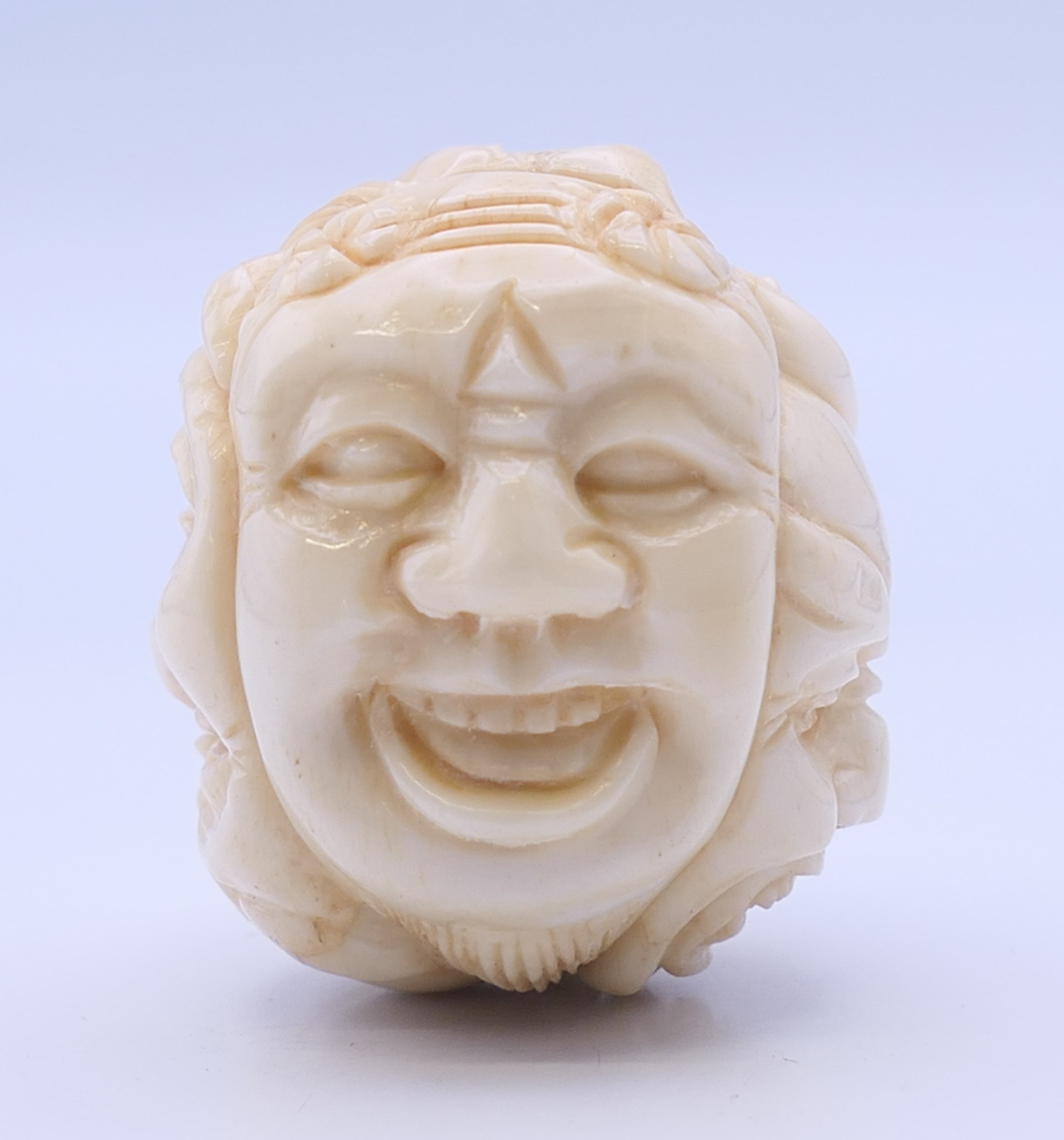 A bone carving formed as various faces. 3.5 cm high. - Image 2 of 4