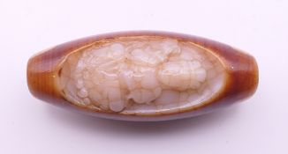A carved agate dzi bead. 5 cm high.