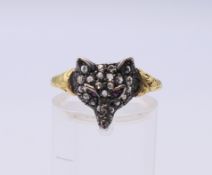 A gold diamond and ruby set fox mask ring. Ring size Q/R. 2 grammes total weight.